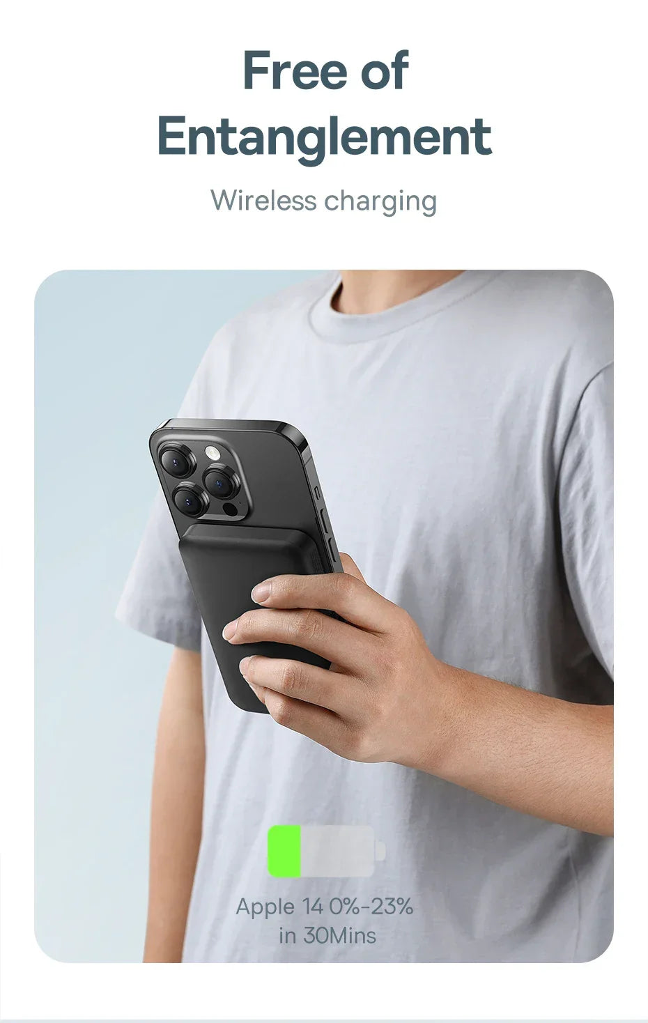 Person holding smartphone with black wireless charging power bank attached