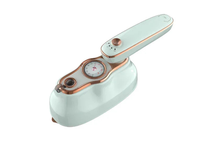 Compact handheld steam iron in white with rose gold accents and temperature dial