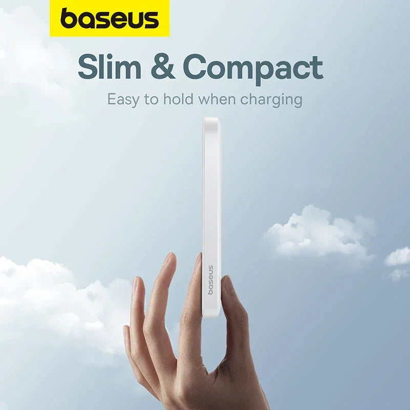 Slim, compact Baseus power bank held in hand against a sky background, easy to hold design.
