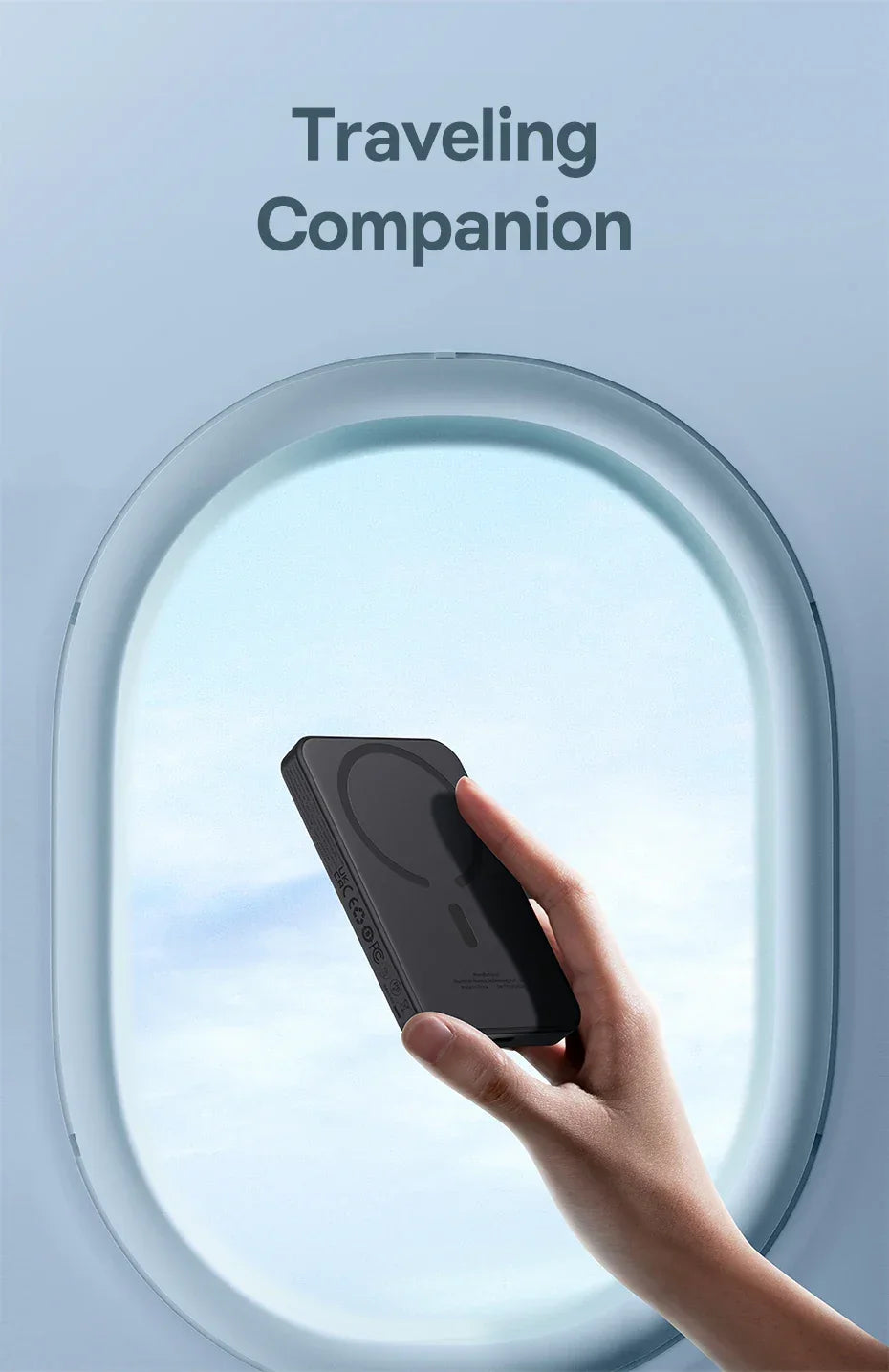 Hand holding a portable power bank by an airplane window, travel accessory concept