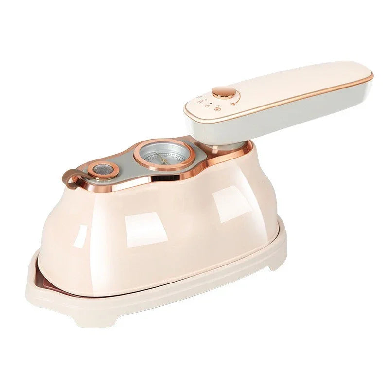 Beige handheld steam iron with rose gold accents on a white background